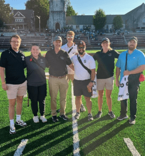 MS Athletic Training students posing for a photo on a football field