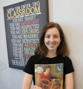 MEd Reading graduate student holding a book