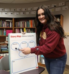 MEd Special Education student standing at a whiteboard