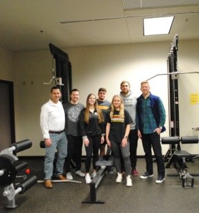 MS Applied Exercise Physiology students and faculty standing in a weight room