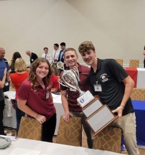 MS Athletic Training students holding a trophy