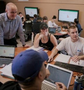 Supply Chain Management students working on a group project in a class