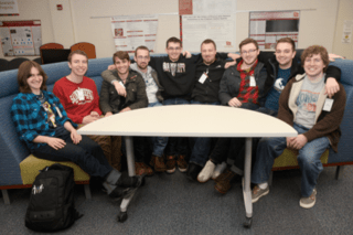 A group sitting at a half circle table. 