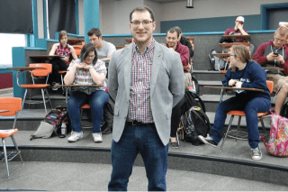 A man standing in front of a class. 