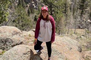 A girl standing on a rock.