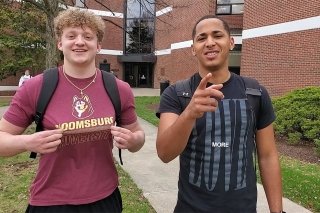 Two men standing in front of a building. 