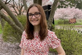 Megan Beck standing in front of a tree. 