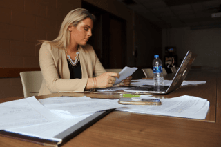 A woman working at a desk.