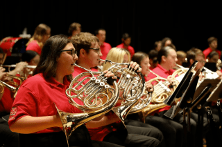 A group playing instruments (band). 