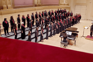 The choir standing in three lines. 