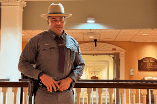 Officer standing in front of a railing. 