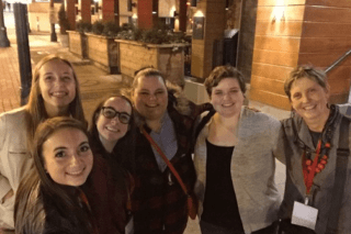 A group of people standing together at night. 