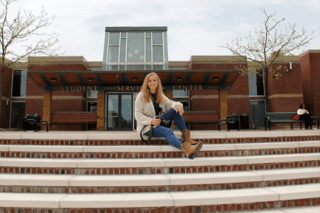 A girl sitting on a staircase. 