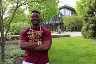 Rashee Hall standing outside with a stethoscope around his neck. 