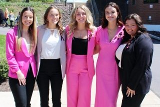 Five girls standing side by side. 