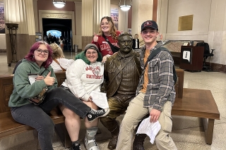 Group sitting around a statue. 