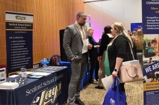 A representative of the Seaford Area School District speaks with a Bloom student at the 2023 Education Expo