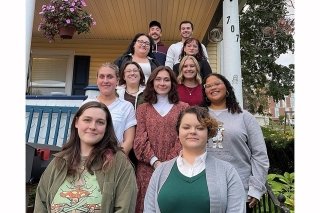 A group standing on the staircase for a photo. 