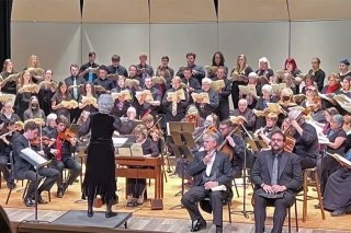 A band on a stage with a band director. 