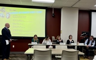 Multiple alumni sitting at a table together during a Commonwealth University's Career Intensive Boot Camp.