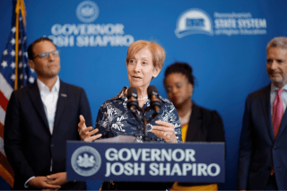 A lady talking behind a podium that says Governor Josh Shapiro