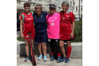 Four women standing side by side. 