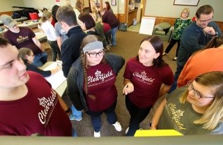 A group of students standing around talking.