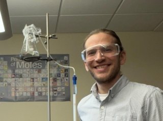 Kyle Root with some chemistry equipment. 