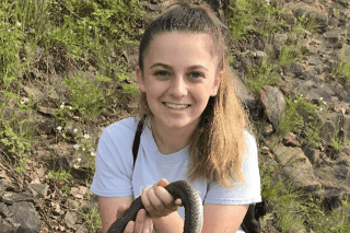 A headshot of a girl outside. 