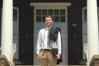 A man standing in front of a building. 