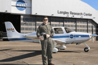 A man standing in front of a plane.