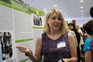 A woman teaching from an information board. 