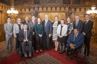 A group of people standing side by side. 