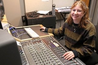 A girl sitting in a studio. 