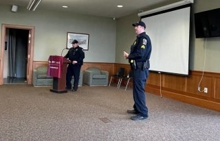 Two people standing in a room. 