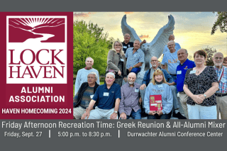 Alumni posing with bald eagle statue.