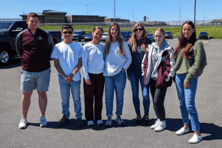 A group of people standing side by side. 