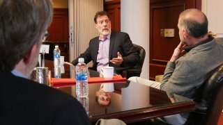 Three people sitting together at a table. 