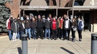 A group of people standing in front of a building. 