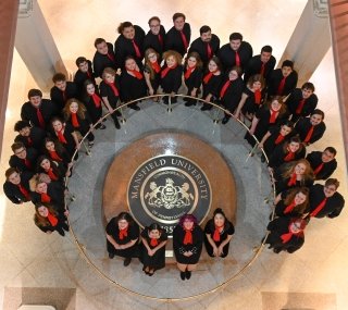 A music group standing in a circle. 