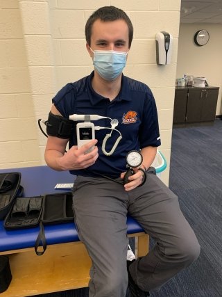 Greg Zappala sitting on a medical bench. 