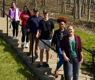 A group of students standing on a staircase. 