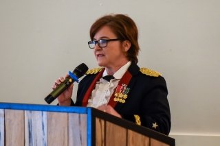 A woman speaking at a podium. 