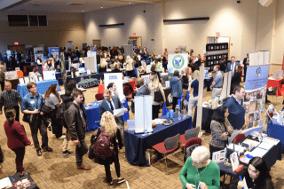 An aerial photo of a  crowd of students wandering through the many booths at a recent Career Connections Expo.