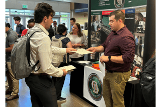 A student speaks to a recruiter from Old Dominion at the latest Career Connection Expo at Commonwealth University