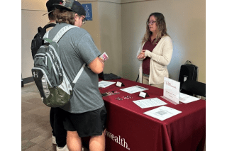 A FCB representative speaks with two students at a recent Career Connections Expo