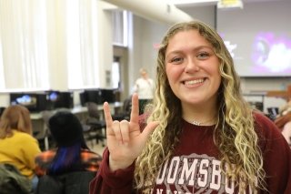 An American Sign Language (ASL)/English Interpreting student at CU-Bloomsburg signing "I love you"