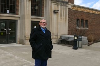 Dick Horton stands in front of Straugh Auditorium at Commonwealth University-Mansfield, formerly Mansfield University of Pennsylvania