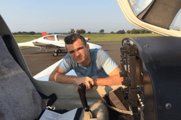 A man leaning on a plane. 