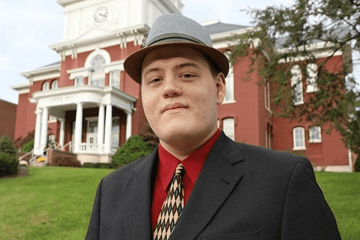 A man standing in front of a building. 